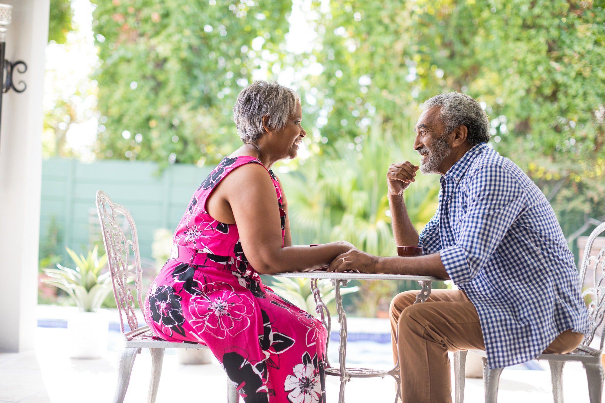 Happy senior couple sitting at table discussing social security and medicare