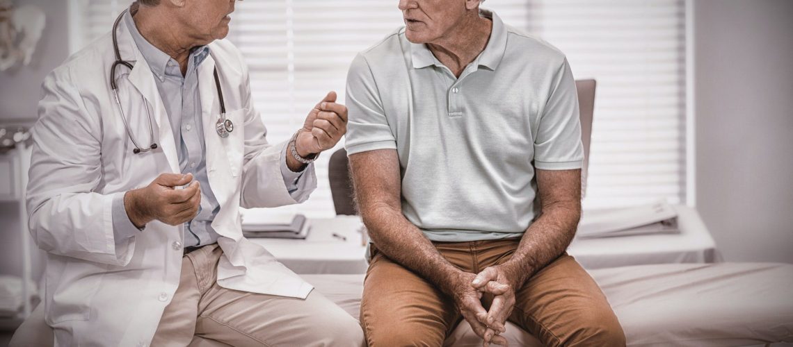 Doctors interacting with senior patient