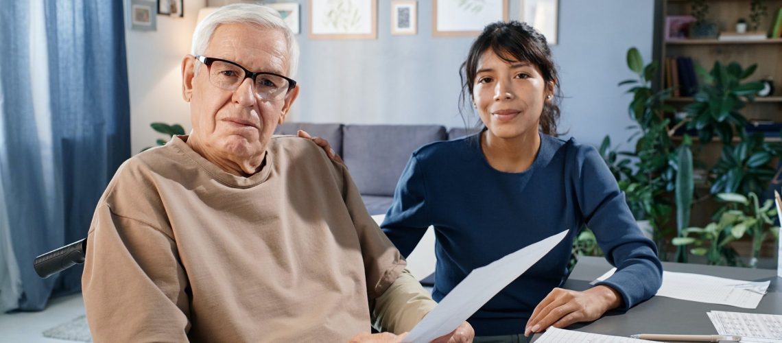 Seniors man discussing his medicare taxes with an assistant.